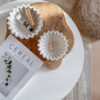 coffee table scalloped dishes on wood tray presenting on the coffee table with cereal book