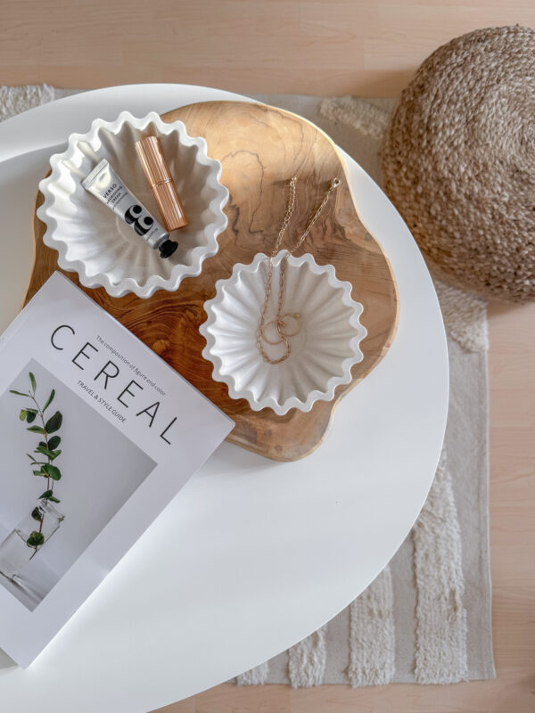 coffee table scalloped dishes on wood tray presenting on the coffee table with cereal book