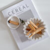 palo santo holder bowl standing on cereal book