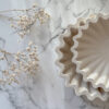 ruffled edge dish in two different sizes presenting on marble table