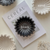 scalloped marble bowl presenting on the table with black and sand color