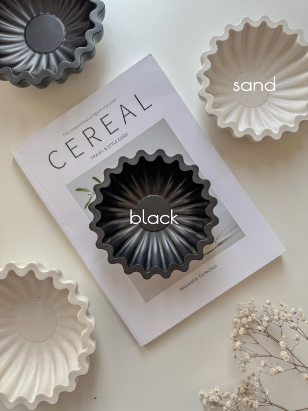 scalloped marble bowl presenting on the table with black and sand color