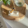 2in1 Incense & Palo Santo Holder on a piece of wood placed on coffee table