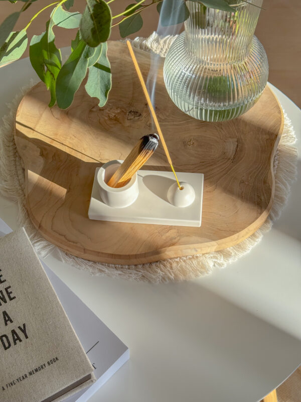 2in1 Incense & Palo Santo Holder on a piece of wood placed on coffee table