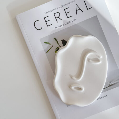 Abstract Face Tray lying on Cereal Magazine