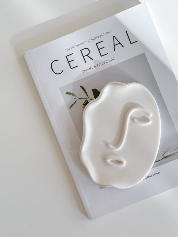 Abstract Face Tray lying on Cereal Magazine