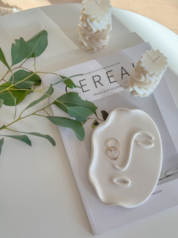 Abstract Face Tray lying on Cereal Magazine